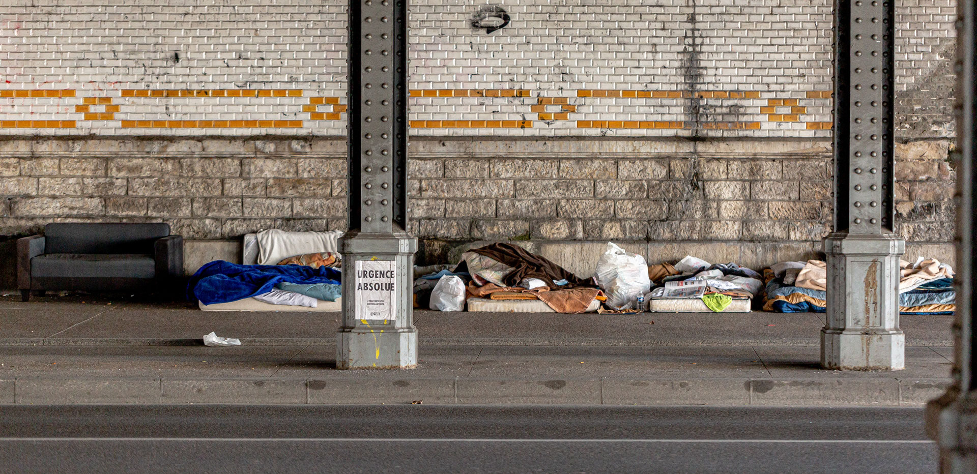 A small homeless encampment under a bridge