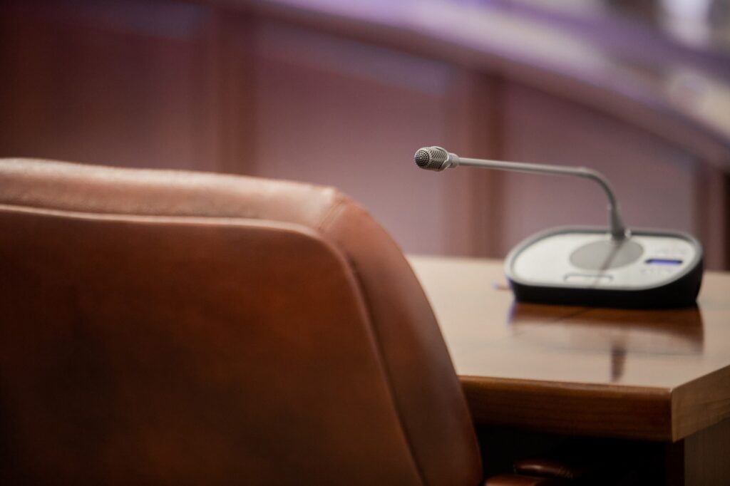 A seat and microphone inside city council chambers