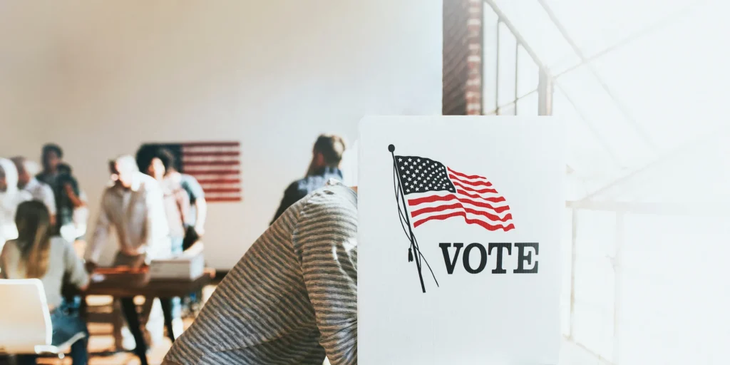 A man voting in a polling location booth