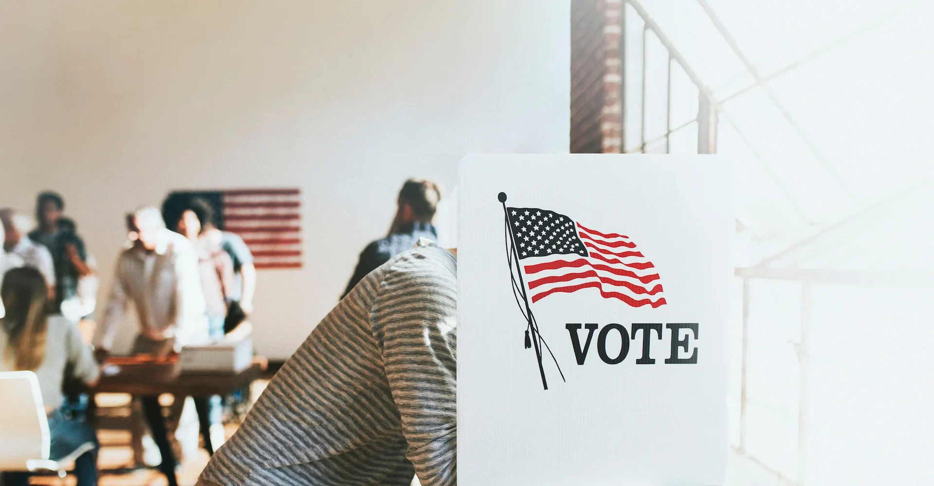 A man voting in a polling location booth